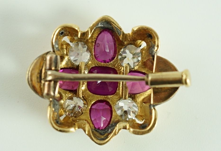 An early 20th century gold, four stone ruby and four stone diamond set brooch (adapted)